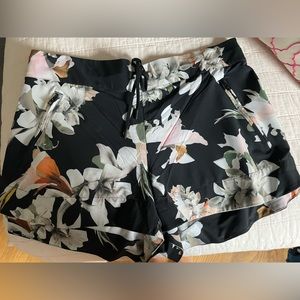 Athleta black floral print shorts in size 12